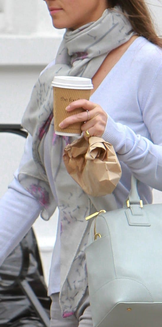 Accentuating her monochrome ensemble, Pippa Middleton adds a touch of flair with her printed grey scarf, subtly highlighted with pops of magenta, creating a stylish statement on the streets of Chelsea