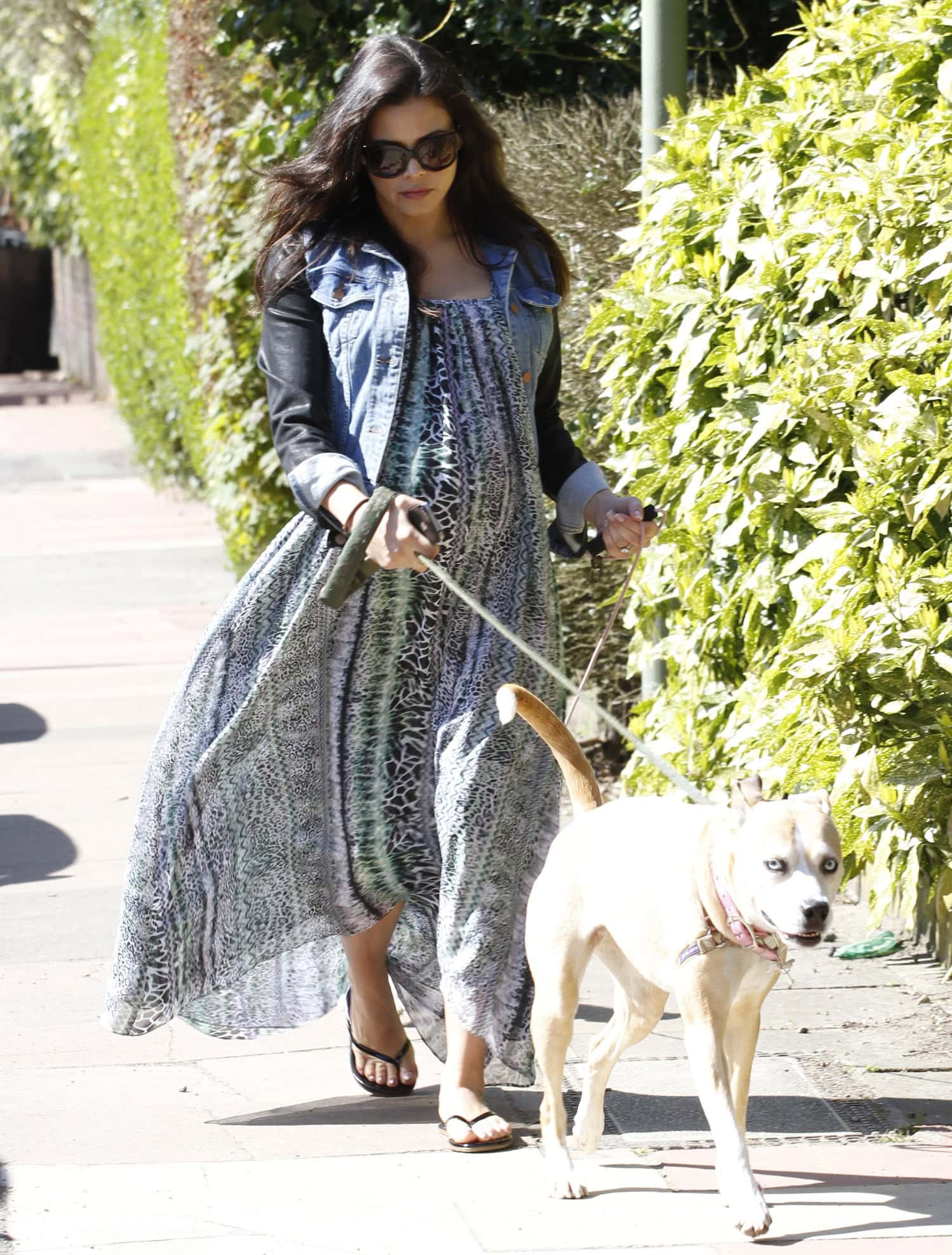 Jenna Dewan-Tatum exuded casual elegance in a flowing printed maxi dress paired with a denim jacket and flip-flops while walking her dog in London