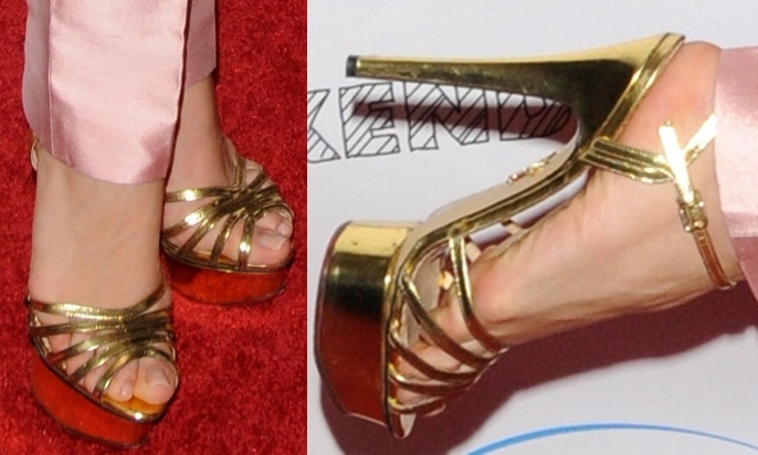 Olesya Rulin shows off her size 6 (US) feet in strappy gold platform sandals