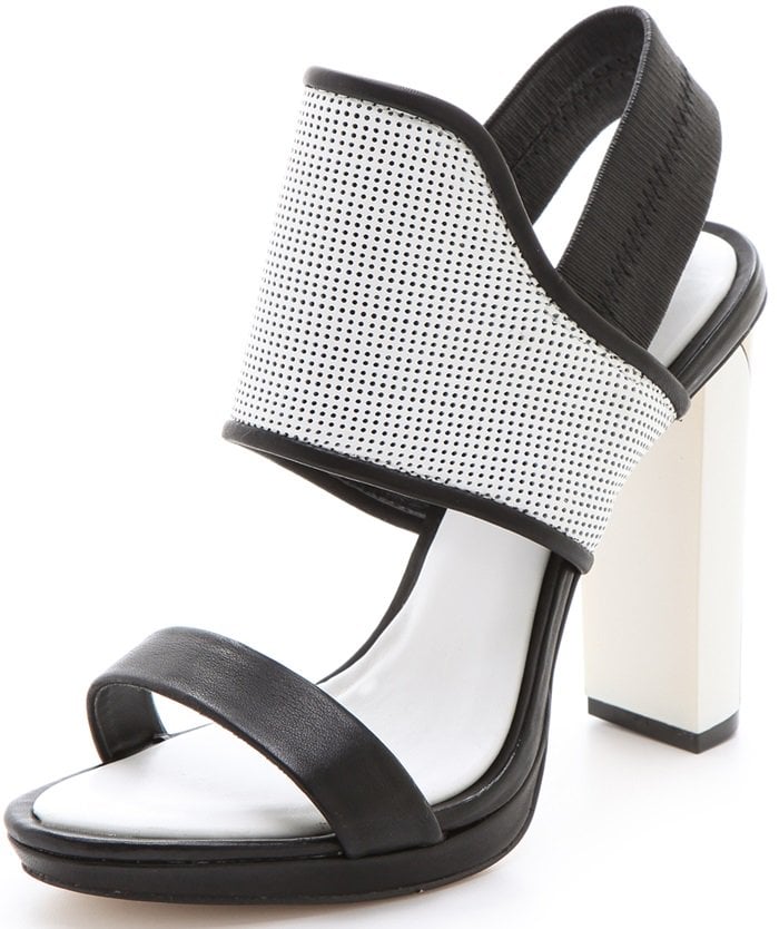 Two-tone leather sandals gain a touch of athletic appeal from a notched, perforated leather panel and an elastic slingback strap, while a sleek swath of metallic acrylic adds shine at the chunky heel.