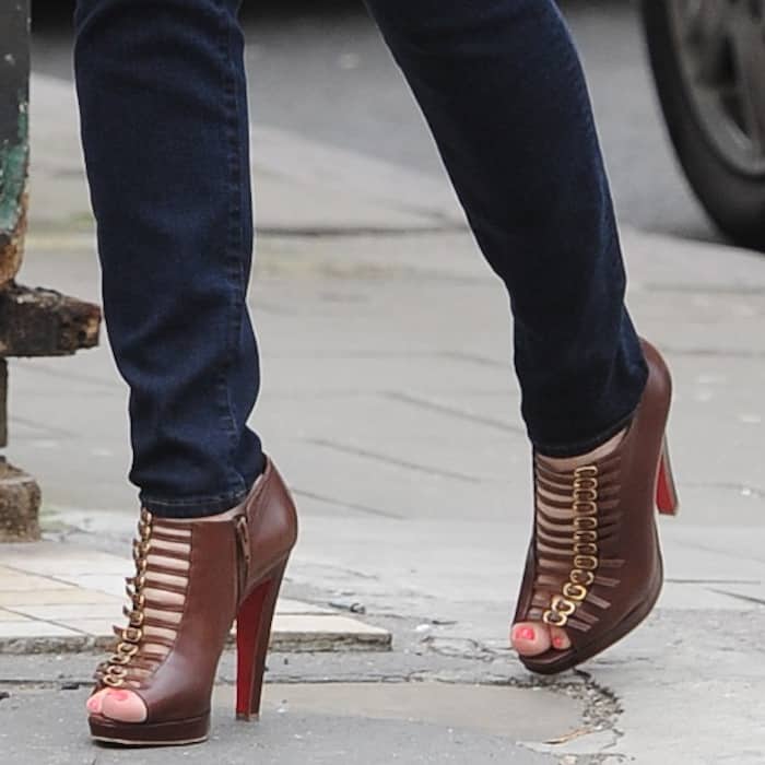 Kelly Brook shows off her feet in Christian Louboutin brown leather buckled 'Manon' booties