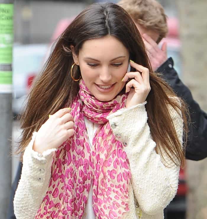 Kelly Brook wears a pink printed scarf with a white knit blouse