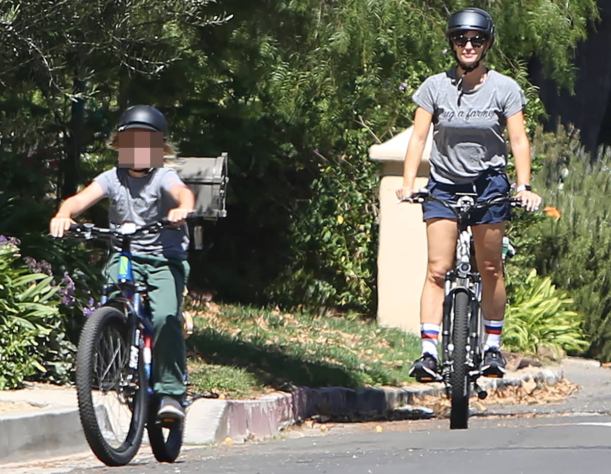 Wearing Brooks Levitate 4 sneakers and a The Uplifters Hug a Farmer tee, Jennifer Garner goes for a bicycle ride with her son Samuel Affleck