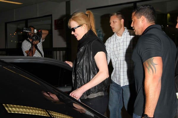 Nicole Kidman being escorted by her bodyguards to a waiting car after arriving at Los Angeles International Airport on August 12, 2013