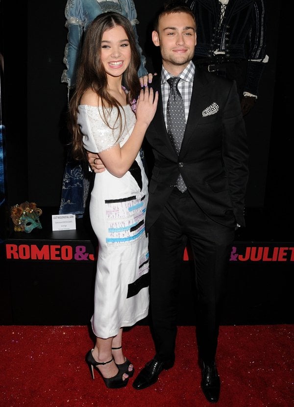 Hailee Steinfeld, in a Prabal Gurung dress and Brian Atwood "Tribeca" platform sandals, cozying up to co-star Douglas Booth at the 'Romeo and Juliet' film premiere in Los Angeles, California, on September 24, 2013