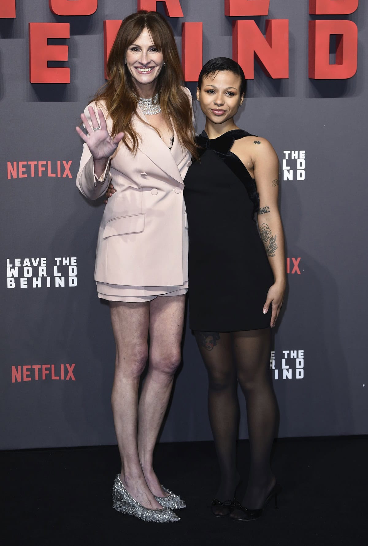 Julia Roberts towers over Myha’la Herrold, with her 5'8" height amplified by sparkling silver heels, highlighting a noticeable height difference on the red carpet