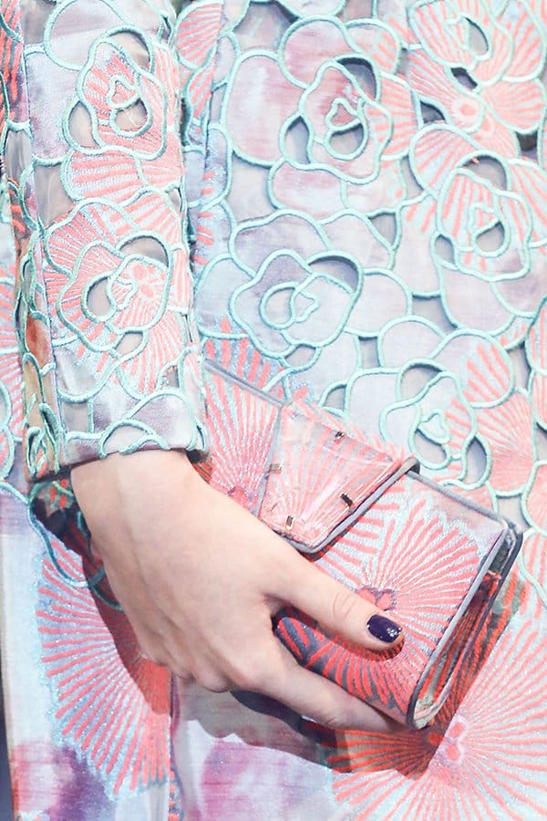 Detailed shot of a pastel floral Giorgio Armani clutch with intricate lace detailing