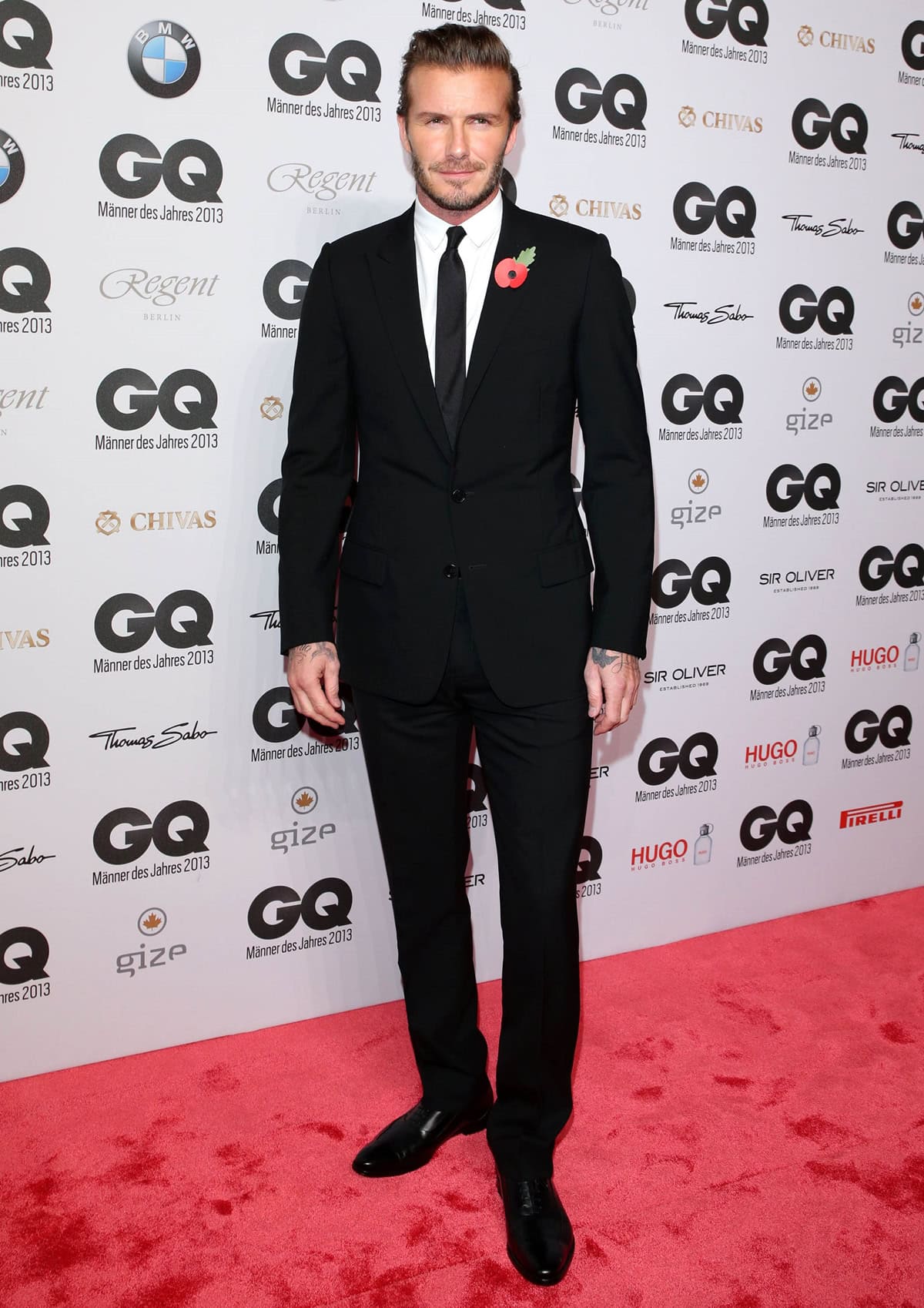 David Beckham accepts the top honor at the 15th Annual GQ Men of the Year Awards in Berlin on November 7, 2013