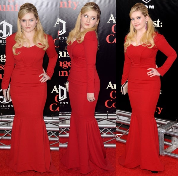 Abigail Breslin stuns in a ruby red Zac Posen gown at the New York premiere of August: Osage County