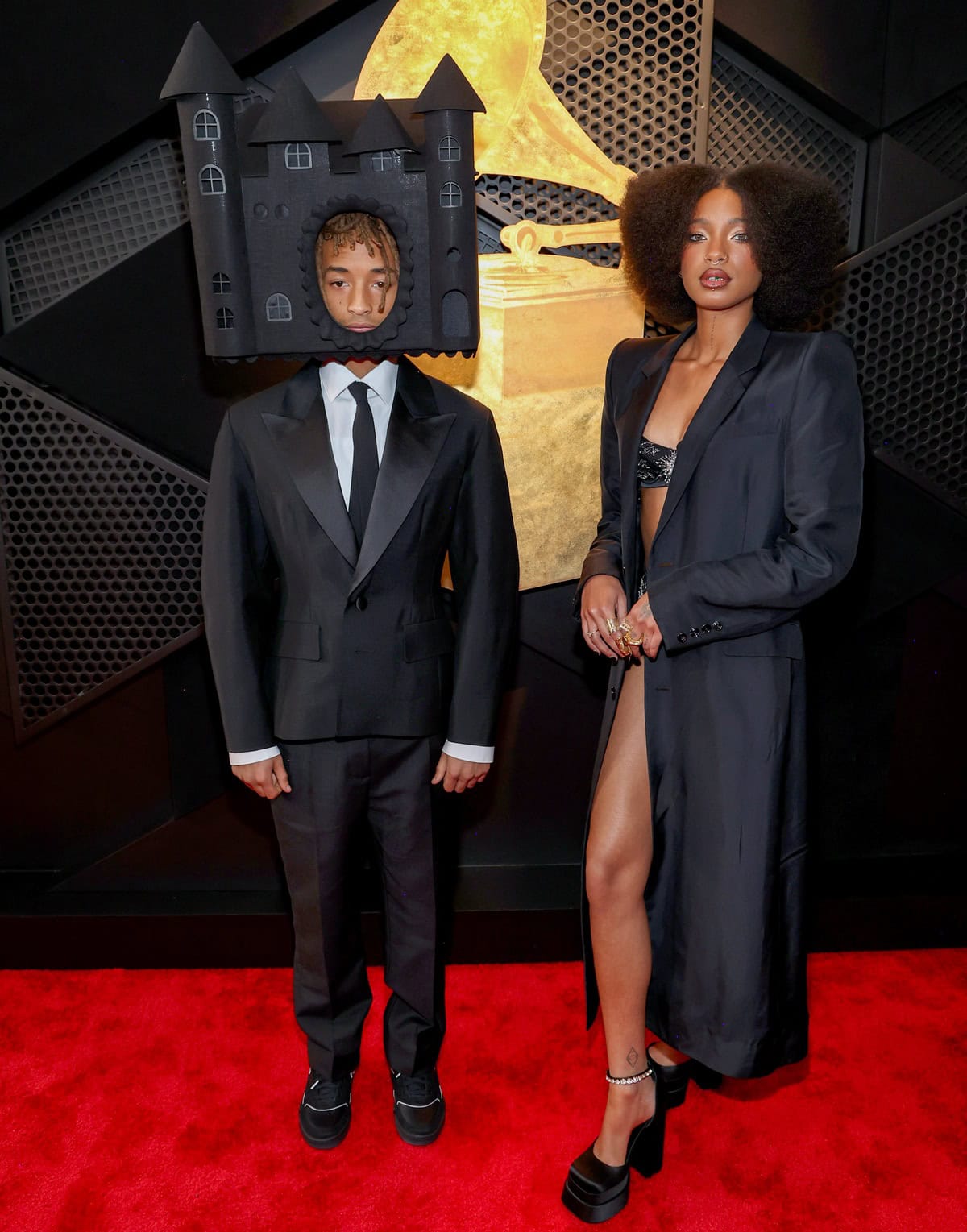 Jaden Smith and Willow Smith made a bold fashion statement at the 67th GRAMMY Awards on February 2, 2025, in Los Angeles—Jaden in a classic Louis Vuitton tuxedo with a striking castle headpiece, and Willow in a sultry lingerie-inspired ensemble paired with towering Versace Medusa Aevitas platform pumps