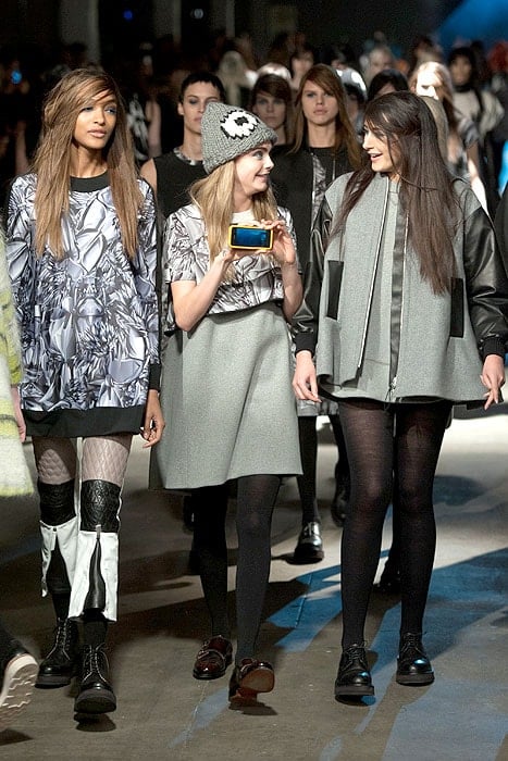 Cara Delevingne holding up her phone at the finale of the Giles Fall 2014 fashion show