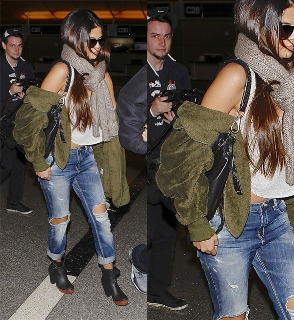 Selena Gomez arrives at LAX with a hidden single-strapped handbag under her arm on February 15, 2014