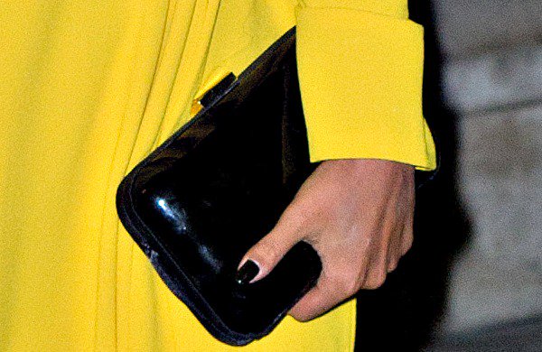 Preeya Kalidas with a sleek black clutch and chic dark manicure