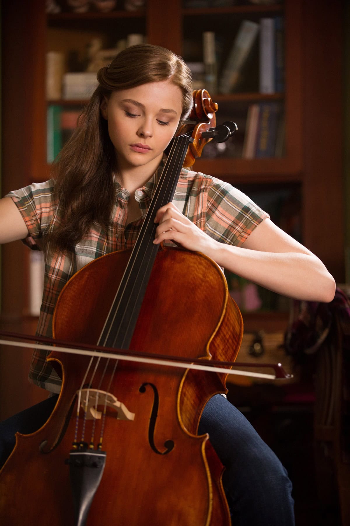 Chloë Grace Moretz as Mia Hall, with a cello double's performance digitally enhanced to include her, in the movie If I Stay