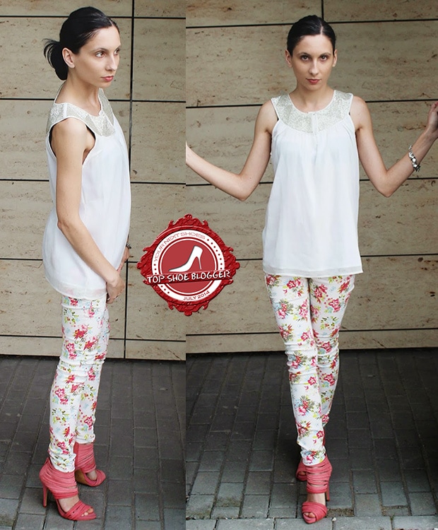 Justyna Zybek wearing a white top, floral pants, and strappy pink sandals