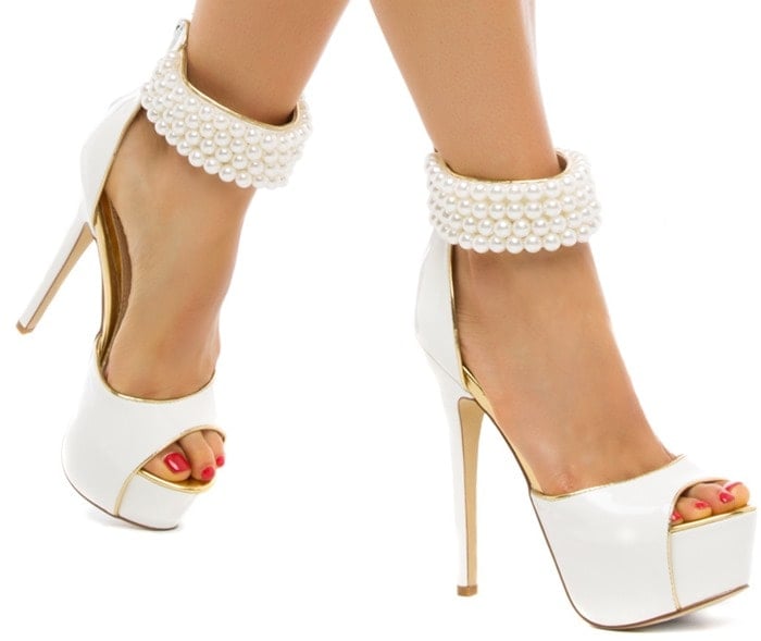 This showstopping sandal rocks patent-effect finish and a bevy of beaded accents on a sleek ankle strap