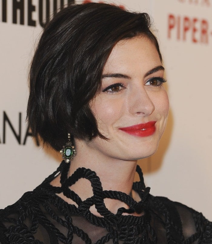 Anne Hathaway donned a stunning black rope-lace dress from the Christopher Kane Spring 2015 collection featuring long sleeves