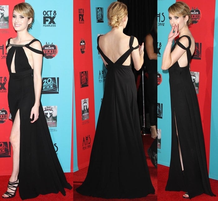 Emma Roberts flaunts her legs in a black gown featuring cutout details, a thigh-high slit, and an embellished neckline