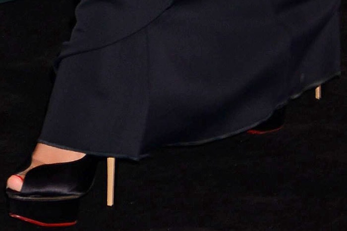 Charlotte Olympia "Daphne" platform pumps peeking out from under the hem of Megan Fox's David Koma dress