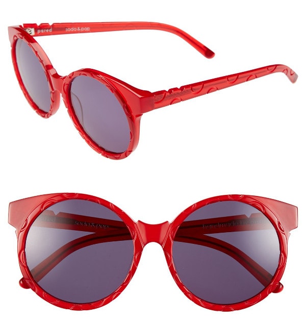 Watermelon-red Japanese acetate frames are engraved with spotty circles and paired with solid purple lenses that'll pique the paparazzi's curiosity