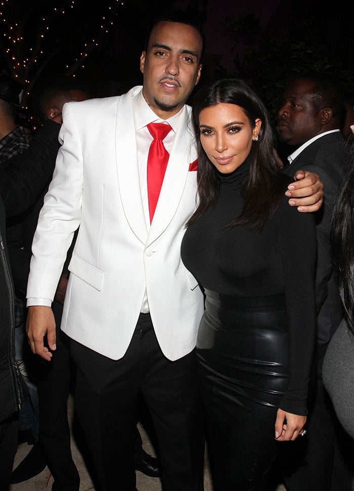 Kim Kardashian, posing with French Montana, in a Wolford turtleneck bodysuit and a leather skirt