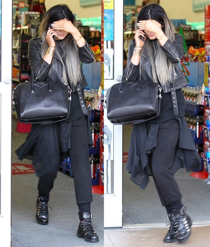 Kylie Jenner wearing a black leather motorcycle jacket and toting a black Givenchy bag