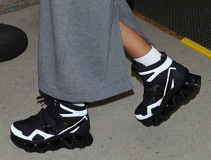 Rihanna Jet-Sets in Shapeless Hoodie Dress and Ninja Hi-Top Sneakers