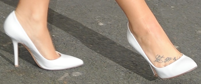 Demi Lovato shows off her feet in white patent leather pumps