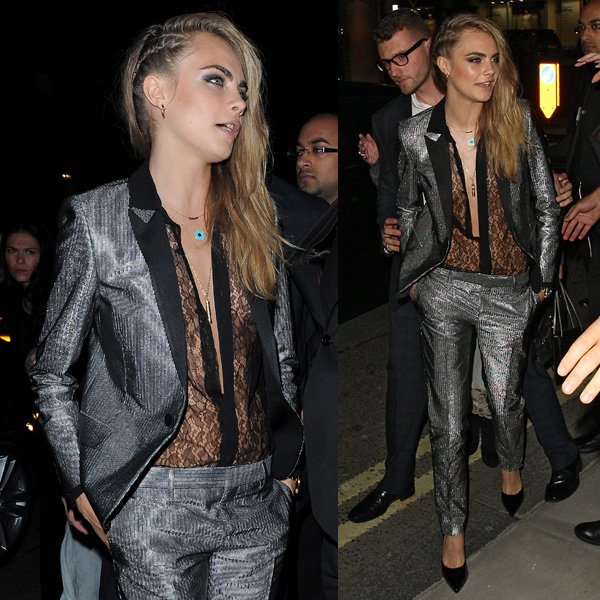 Cara Delevingne paired a black lace blouse with a two-piece metallic pinstriped blazer-and-pants set