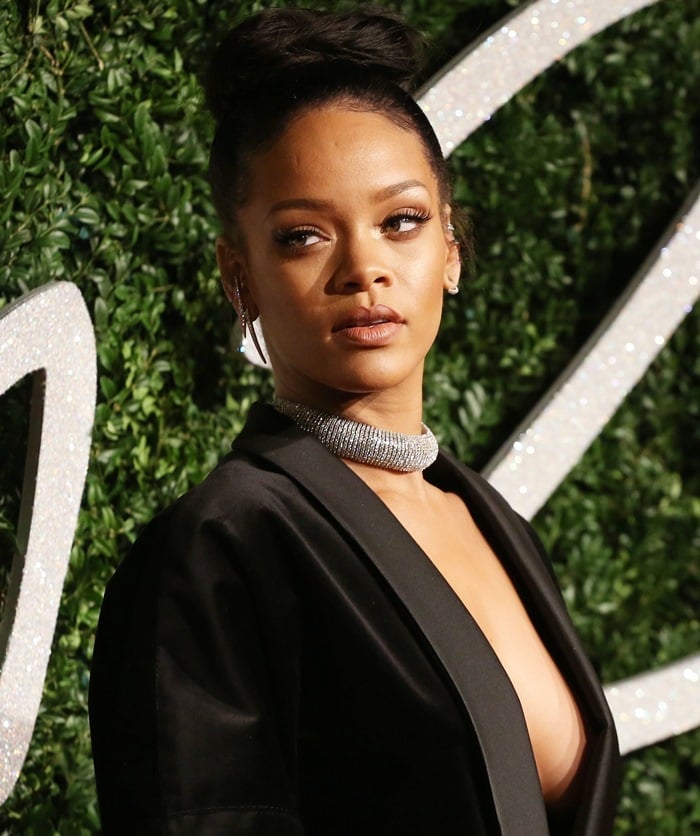 Rihanna flashing her cleavage while wearing just a blazer on the red carpet at the 2014 British Fashion Awards held at London Coliseum in London, England, on December 1, 2014