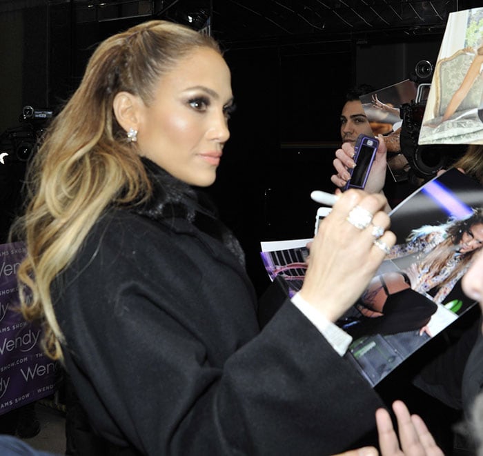 Jennifer Lopez signs autographs for fans as she arrives at "The Wendy Williams Show"