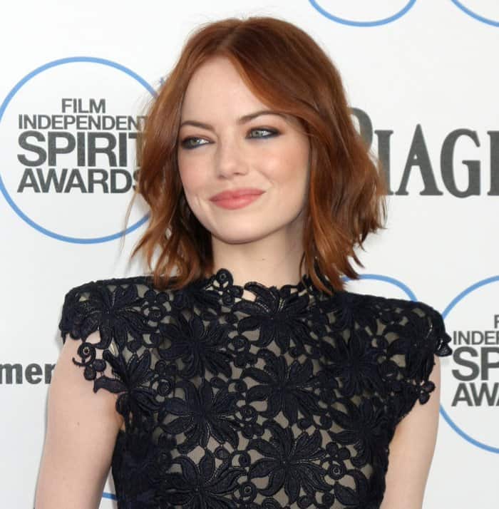 Emma Stone's makeup featured a subtle smoky eye and a soft pink lip, perfectly complementing her red hair, which was styled in loose waves at the 2015 Film Independent Spirit Awards