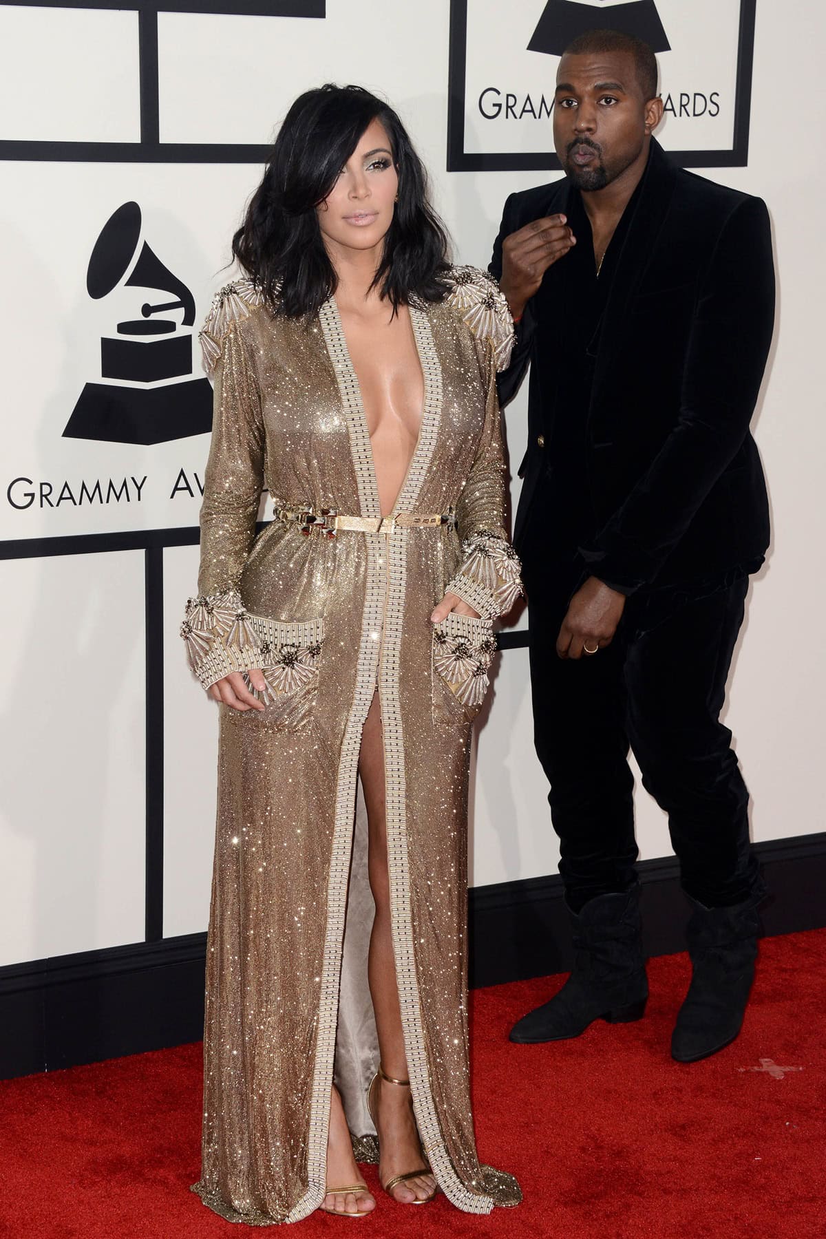 Kim Kardashian dazzles in a gold Jean Paul Gaultier gown while Kanye West opts for sleek black velvet at the 2015 Grammy Awards