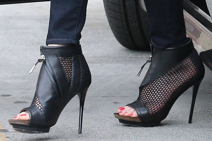 Gwen Stefani's boots made of mesh and leather with asymmetrical zippers