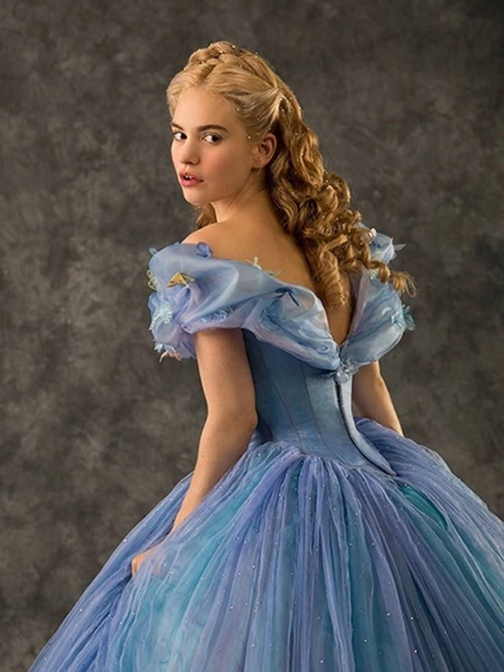 Lily James as Cinderella, showcasing her tiny waist accentuated by a corset and a voluminous tulle skirt