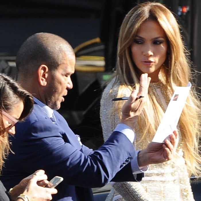Jennifer Lopez engaged in conversation while preparing for American Idol in Los Angeles, looking stunning in a beige beaded mini dress by Nicolas Jebran