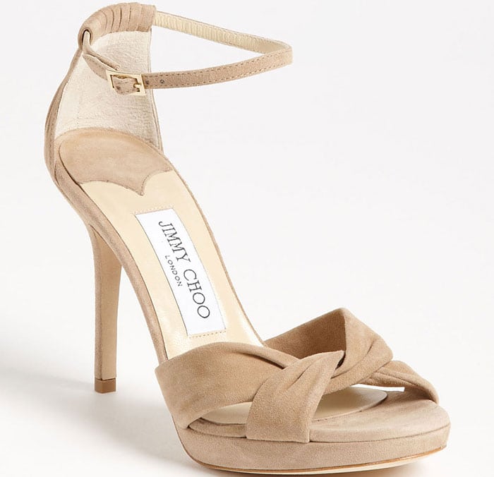 Prim pleats finish the feminine appeal of a twisted, ankle-strap sandal in lusciously soft suede.