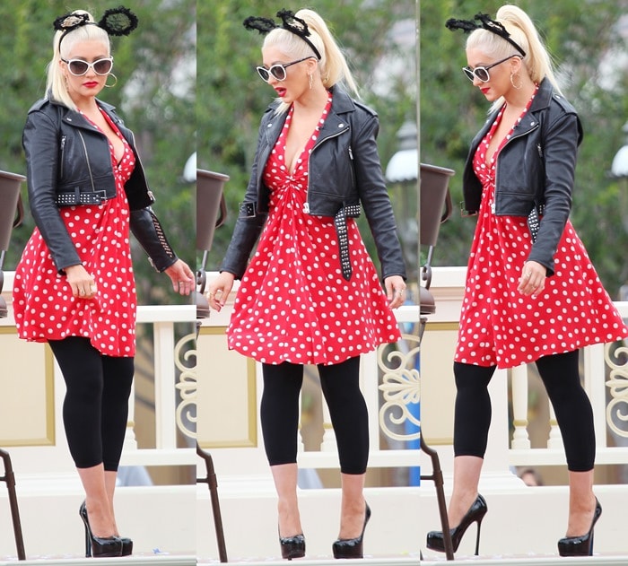 Christina Aguilera flashed her legs in a red polka-dot print dress and a cropped leather jacket