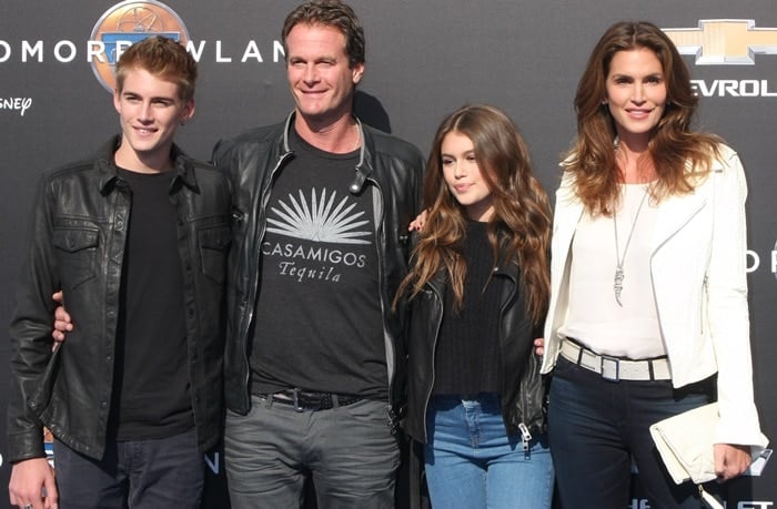 Cindy Crawford and her family coordinate in stylish casual looks, with Cindy in a white leather jacket and jeans, while Kaia, Rande, and Presley complement in dark jackets at the Tomorrowland premiere