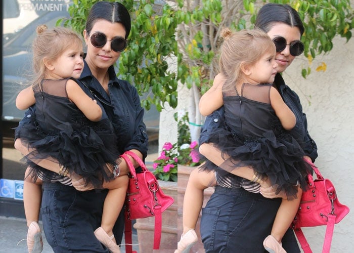 Kourtney Kardashian carrying the adorable Penelope Scotland Disick into the dance studio