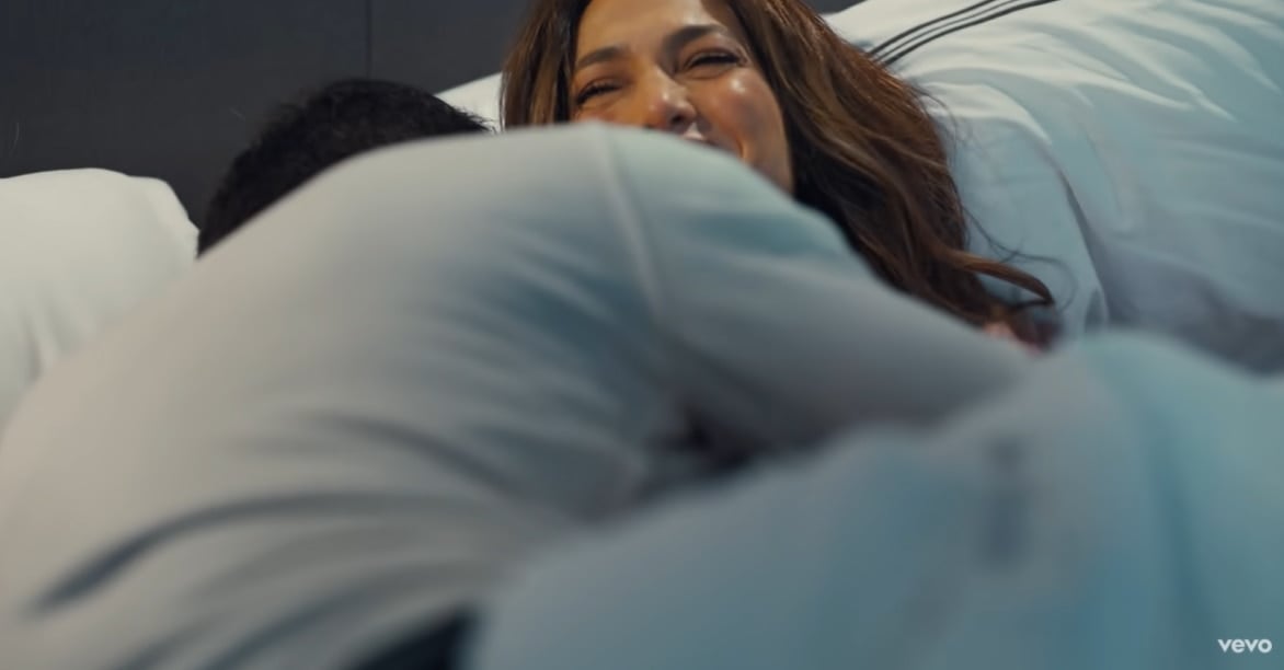 Jennifer Lopez is shown cuddling and laughing in bed with Ben Affleck in a music video for her "Marry Me" ballad