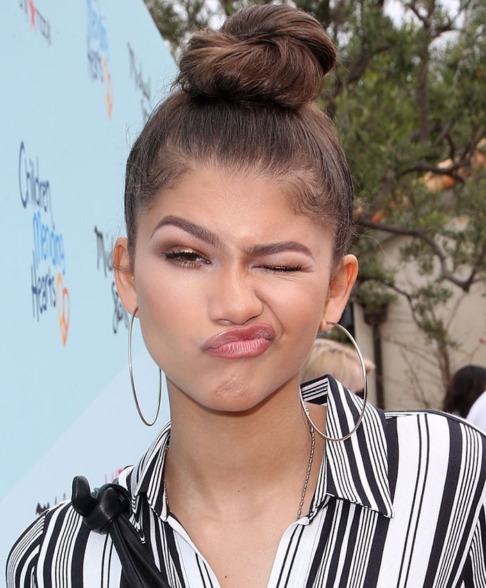 Zendaya Arrives at a Charity Event in Bold Striped Dress and Stuart ...