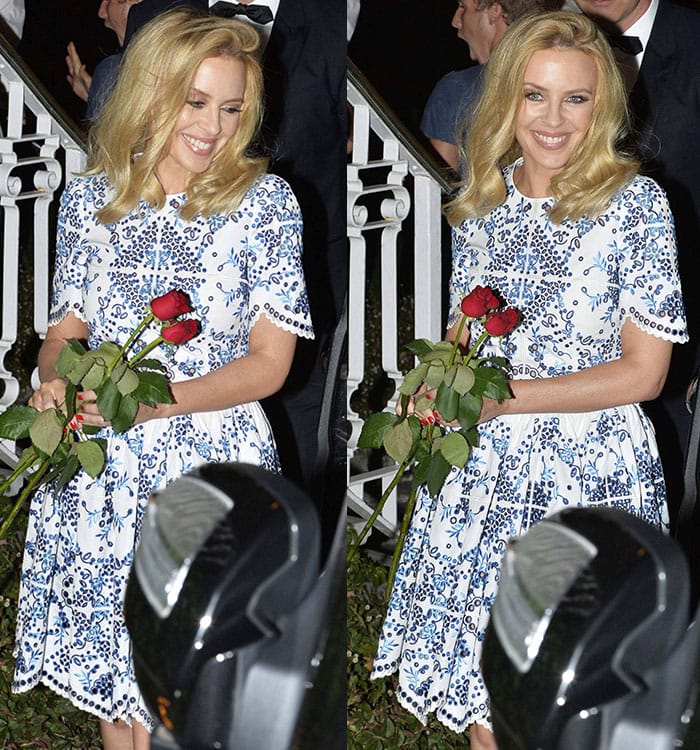 Kylie Minogue's blonde hair was worn down with a deep side parting