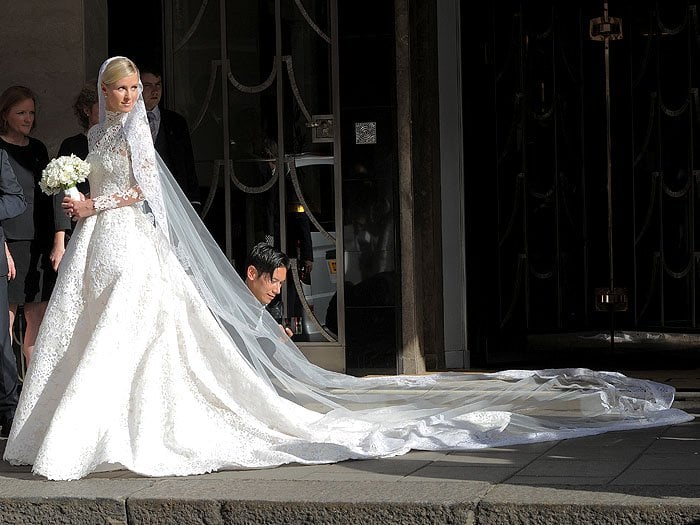 Nicky Hilton in her Valentino Couture wedding gown made of guipure lace, embellished with crystals, and topped off with a 3 meter long train