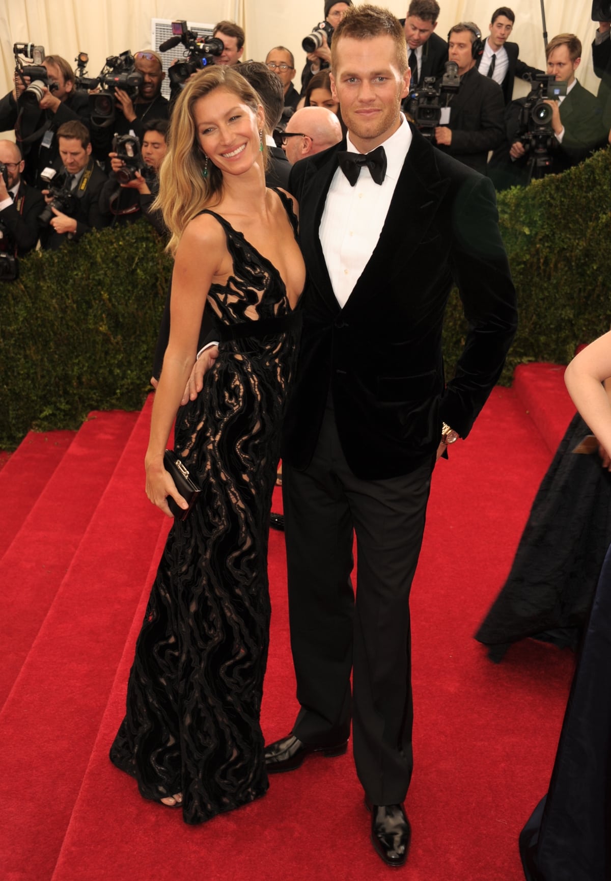 Gisele Bündchen in a plunging black velvet Balenciaga gown with Tom Brady at the 2014 Met Gala