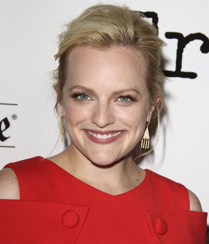 Elisabeth Moss styles her blonde hair up for her movie premiere look