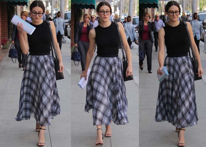 Emmy Rossum holds papers in one hand and carries a shoulder tote in Beverly Hills