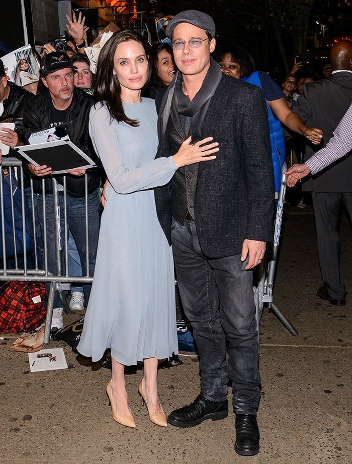 Angelina Jolie poses for photos at the premiere of "By the Sea" with husband Brad Pitt