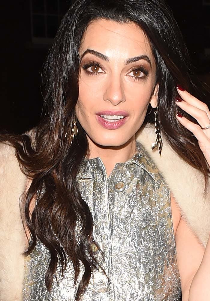 Amal Clooney arrives at Charlotte Tilbury's "Naughty Christmas Party" flagship store launch in London on December 3, 2015