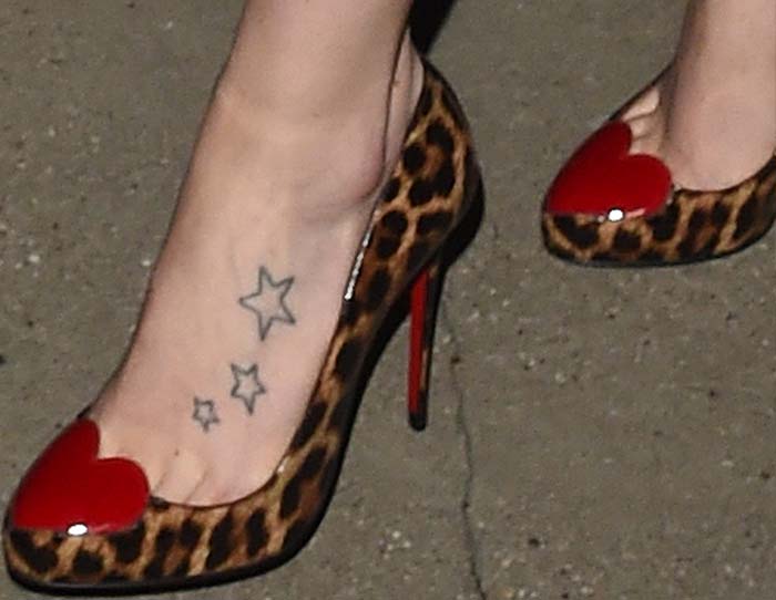 Daisy Ridley's feet and star tattoos in Christian Louboutin heart-and-leopard-print pumps